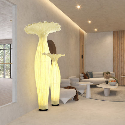 Vaso fabric floor lamp filling a dark living room corner with a soft warm glow from top to bottom