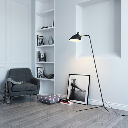 Vega mid century floor lamp next to reading armchair modern living room matte black sculptural statement white neutral interior