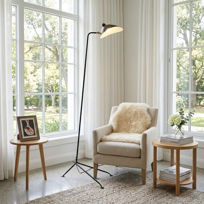 Vega tripod floor lamp behind sofa corner positioned long articulated arm reaching over seating area modern interior