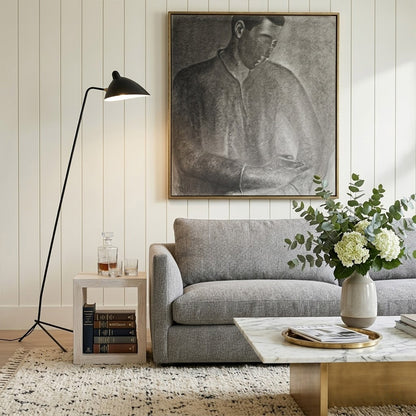 Vega tripod floor lamp behind sofa corner positioned long articulated arm reaching over seating area modern interior