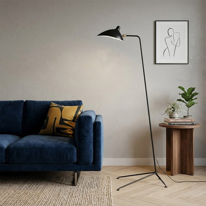 Vega tripod floor lamp behind sofa corner positioned long articulated arm reaching over seating area modern interior