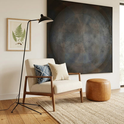 Vega mid century floor lamp next to reading armchair modern living room matte black sculptural statement white neutral interior