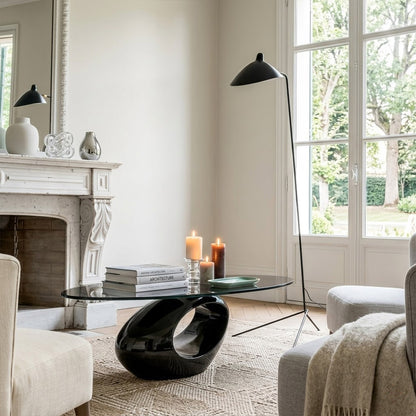 Vega tripod floor lamp behind sofa corner positioned long articulated arm reaching over seating area modern interior