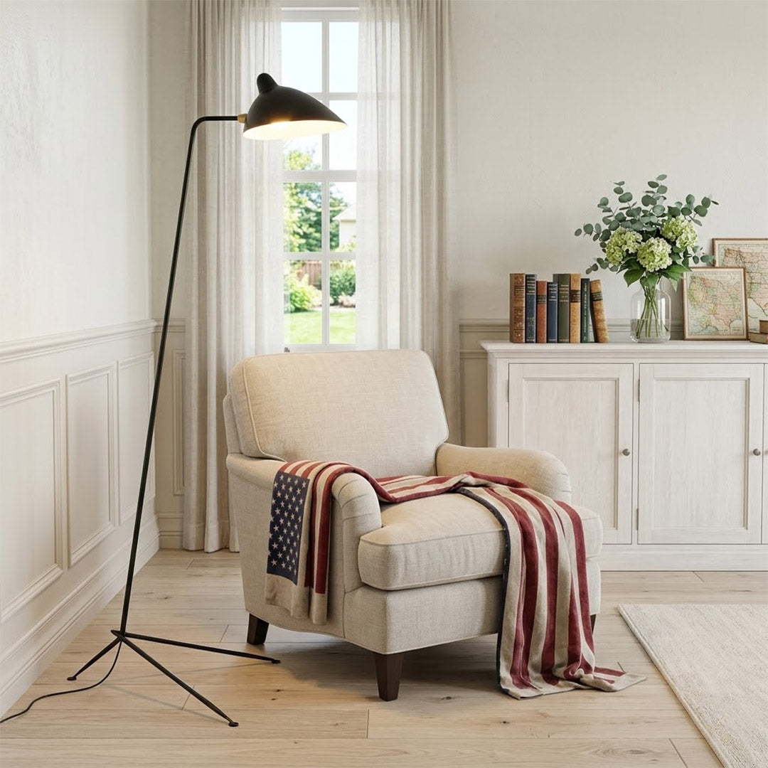 Vega mid century floor lamp next to reading armchair modern living room matte black sculptural statement white neutral interior