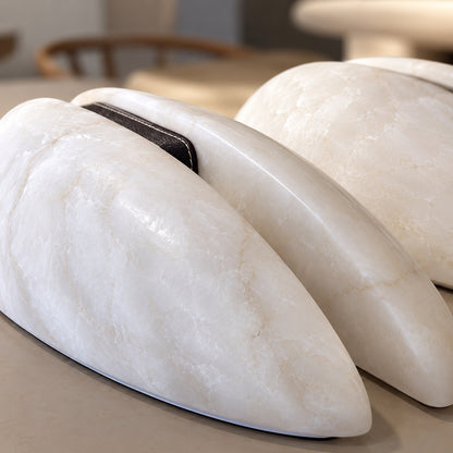 Detail of the dark leather accent band at the center of the Velo alabaster sconce
