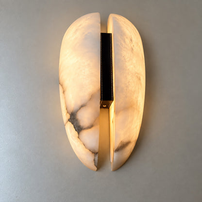 Close-up of natural veining glowing through the alabaster panels of the Velo sconce