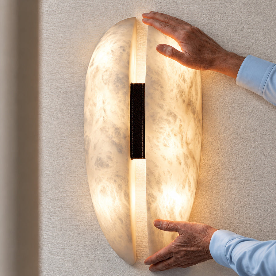 Close-up of natural veining glowing through the alabaster panels of the Velo sconce