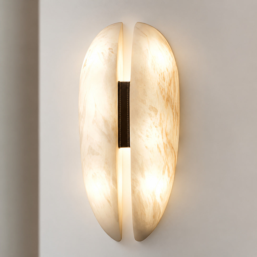 Close-up of natural veining glowing through the alabaster panels of the Velo sconce
