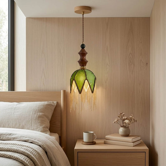 Verde green tassel pendant light beside bed warm glow boho bedroom interior with plants