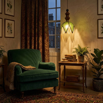 Verde green tassel pendant light beside bed warm glow boho bedroom interior with plants