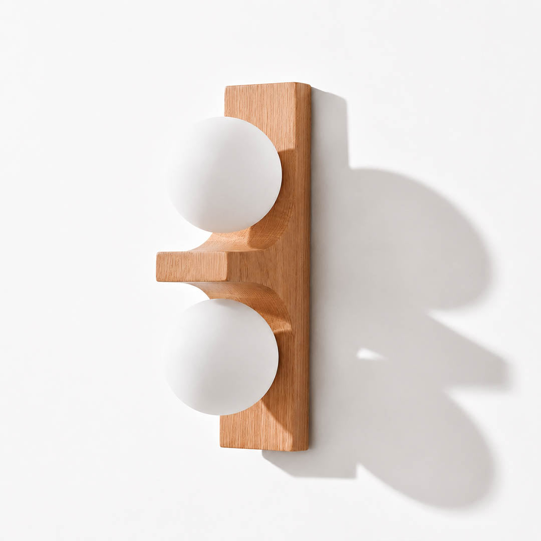 Verena double wall sconce short oak light wood two white glass globes compact white background front view