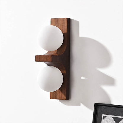 Verena double wall sconce short walnut dark wood two white glass globes compact white background front view