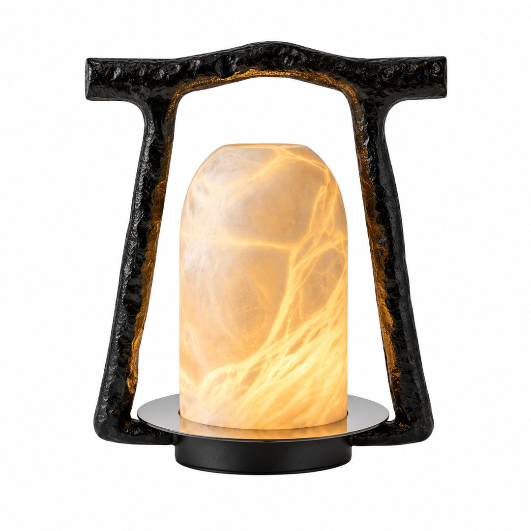 Volta alabaster table lamp with a black arch frame and glowing alabaster dome on a nightstand
