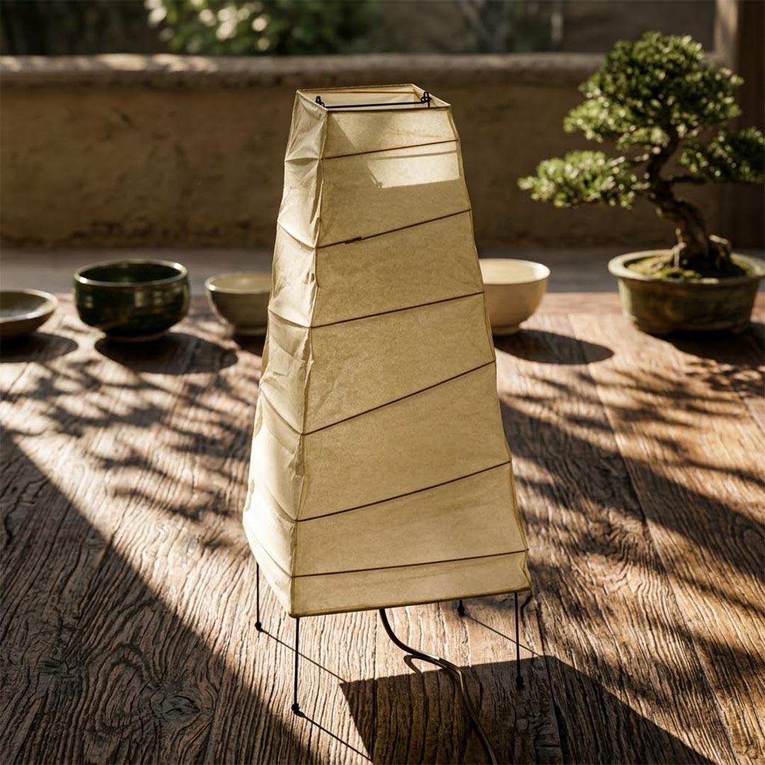Unlit Washi Paper 4N Obelisk Lamp standing in strong afternoon sunlight next to a miniature bonsai tree by Stuber Lighting.