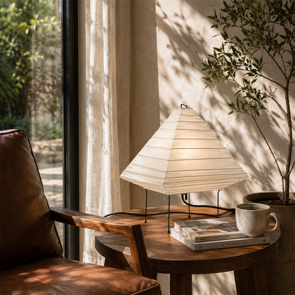 Cozy wabi-sabi living room reading corner featuring pyramid paper table lamp - stuberlighting