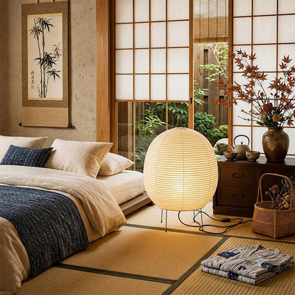 Zen style bedroom interior with a round paper lantern lamp by tatami bed - stuberlighting