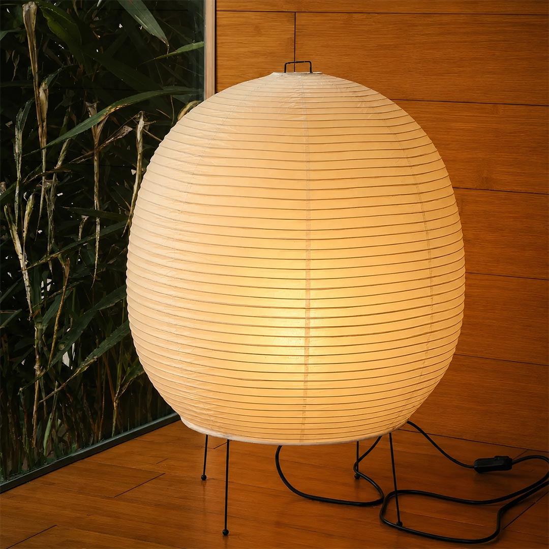 Spherical Washi paper lantern lamp glowing on a minimalist wooden floor - stuberlighting