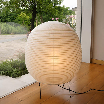 Spherical Washi paper lantern lamp glowing on a minimalist wooden floor - stuberlighting