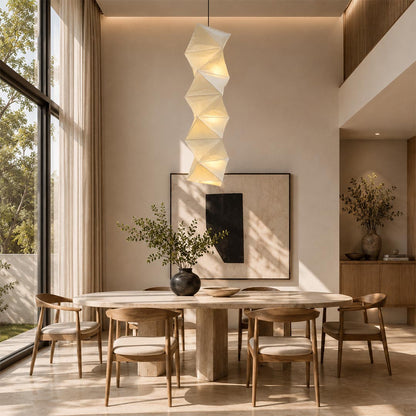 Single vertical Washi Paper L8 Pendant Light centered above an elegant wooden dining set in a bright room by Stuber Lighting.