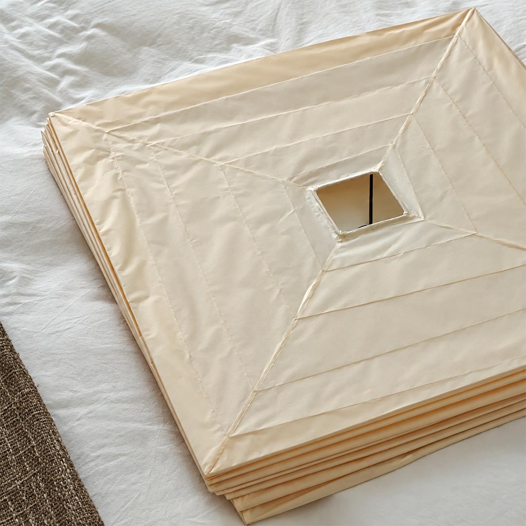 Close-up detail of the folded washi paper square cube pendant light showing its natural paper texture and flat pack design