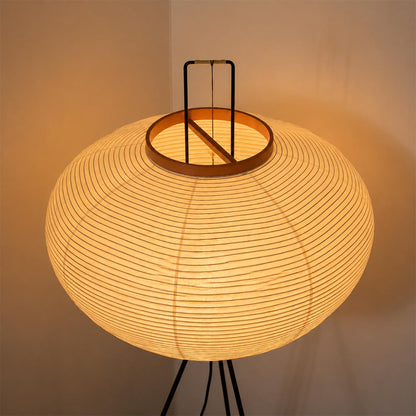 Detail shot of the top handle and orange wooden collar of the washi paper tripod floor lamp