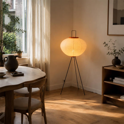 Washi paper tripod floor lamp creating soft ambient light in a minimalist dining area