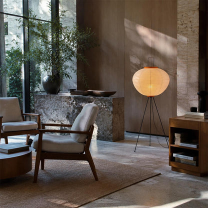 Washi paper tripod floor lamp styled in a bright minimalist living room with wooden furniture