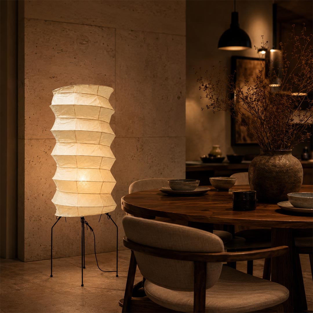Moody dining room corner beautifully enhanced by a glowing ribbed Washi Paper UF2-31N Lantern Lamp by Stuber Lighting.