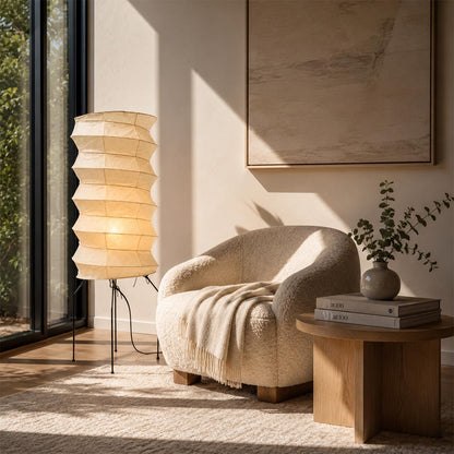 Aesthetic Washi Paper UF2-31N Table Lamp lighting up a cozy reading nook with a plush boucle armchair by Stuber Lighting.
