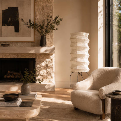 Washi Paper UF2-31N Table Lamp illuminating a cozy lounge corner next to a modern stone fireplace by Stuber Lighting.
