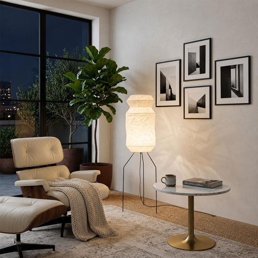 Cozy night-time living room scene featuring a glowing Washi Paper UF3-L6 Floor Lamp by a gallery wall by Stuber Lighting.