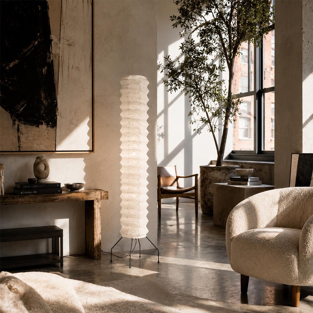 Sunlit modern entryway featuring a striking, tall Washi Paper UF4-31N Totem Floor Lamp on wooden flooring by Stuber Lighting.