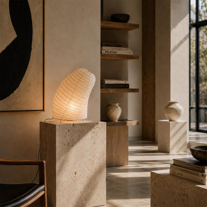 Slanted Washi Paper VB-13T Table Lamp showcased on a stone pedestal pillar in an organic modern interior by Stuber Lighting.