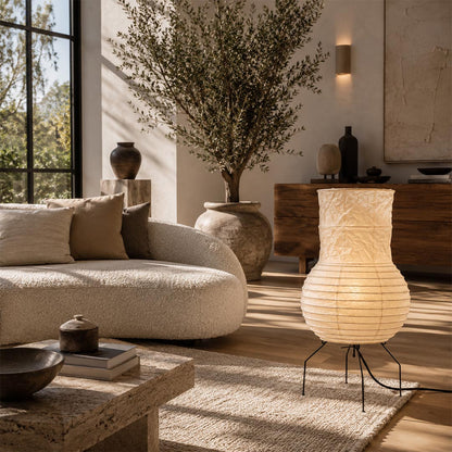 Sculptural Washi Paper Zara Lamp styled next to a curved boucle sectional sofa under warm afternoon sunlight by Stuber Lighting.
