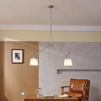 Wren swing arm pendant illuminating reading corner armchair warm parchment glow library at dusk cozy interior