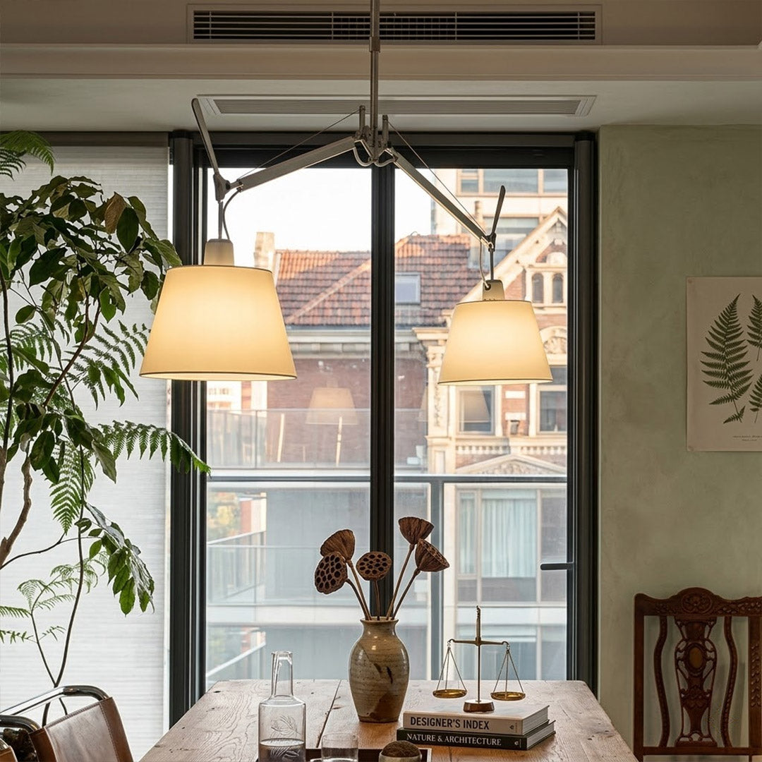 Wren swing arm pendant in modern library study room parchment paper warm amber glow vintage filament bulbs leather chair