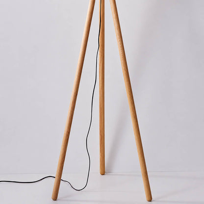 Zucca wood slat floor lamp tripod three wood legs stable base natural wood grain detail close up structure sturdy