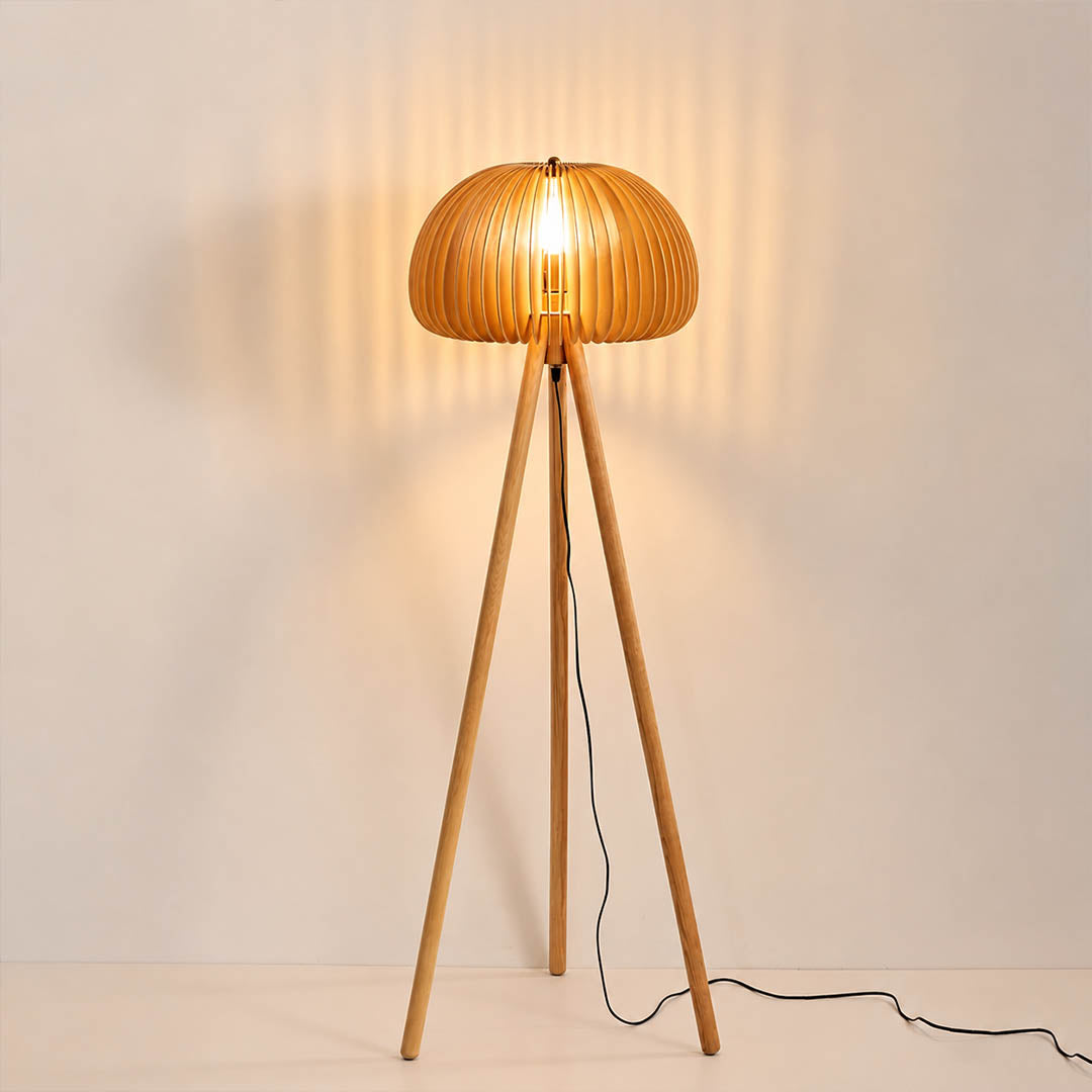 Zucca wood slat floor lamp illuminated warm glow through natural wood slats pumpkin shade tripod rustic cozy white background front view